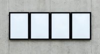 Four blank white frames in black borders mounted on concrete wall for gallery exhibition or artwork display mockup.