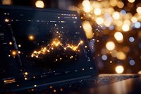 Glowing financial chart on laptop screen with golden bokeh lights in background creating atmospheric business analytics visualization.