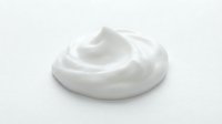Creamy white whipped texture isolated on white background, suitable for cosmetics, skincare, and beauty product packaging design mockups.