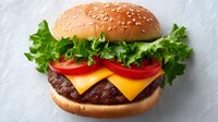 Fresh cheeseburger with beef patty, cheese, lettuce and tomato on sesame bun. Classic American fast food meal ready for restaurant menu or advertising.