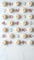 Autumn flat lay pattern with white pumpkins, pink flowers and blue crystals on marble background. Seasonal decoration arrangement for fall design projects.