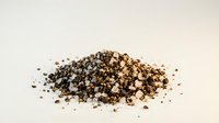 Crushed black peppercorns spice pile isolated on white background for culinary seasoning and cooking ingredient applications.
