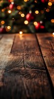 Rustic wooden table surface with defocused Christmas lights and decorations creating magical bokeh effect in background, festive holiday atmosphere.