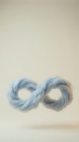 Soft blue infinity symbol made of flowing fabric or smoke against neutral beige background representing endless possibilities and eternal concepts.