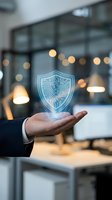 Businessman holding glowing digital shield with circuit board pattern in modern office, representing cybersecurity, data protection, and network security solutions for business.