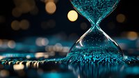 Digital data stream flowing through hourglass shape on dark background with blue technology pattern and bokeh lights, representing time and information flow.