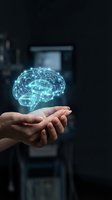 Glowing digital brain hologram floating above open hands in dark futuristic environment representing artificial intelligence and neural networks.