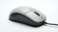 Classic wired computer mouse with scroll wheel isolated on white background, side view closeup for tech and office design use.