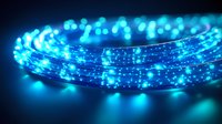 Glowing blue LED light rope creates magical atmosphere with blurred bokeh effect against dark background, modern illumination for festive decor and events.