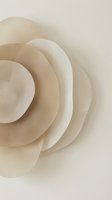 Abstract beige paper flower with layered petals creating dimensional spiral pattern for modern minimalist design projects and elegant decor applications.