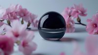 Black spherical cosmetic jar with chrome band surrounded by pink peonies on neutral surface, suitable for beauty product packaging mockups and skincare branding designs.