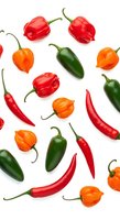 Assorted fresh peppers including red bell peppers, green jalapenos, orange habaneros, and red chili peppers arranged on white background for culinary and food design projects.