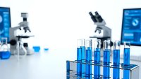 Modern laboratory with blue chemical samples in test tubes and microscopes for scientific research and medical analysis experiments.