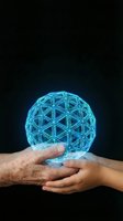 Hands holding glowing blue geometric sphere with triangular wireframe pattern on dark background for technology and innovation concepts.