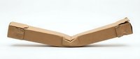Cardboard packaging corner protector strip isolated on white background for shipping and transport protection applications.