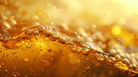 Golden liquid wave with bubbles and splashes in macro photography against blurred warm background with bokeh lights and dynamic flowing motion.