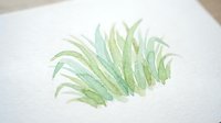 Watercolor green leaf painted on textured white paper with organic brushstrokes and natural botanical details for artistic projects.
