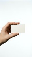 Hand holding blank white business card on neutral background for branding and corporate identity design mockup.