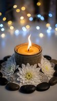 Burning candle surrounded by white chrysanthemum flowers and dark stones with warm bokeh lights creating peaceful spa atmosphere for relaxation and wellness.