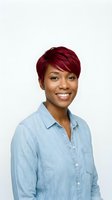 Confident African American woman with burgundy pixie cut hairstyle wearing denim shirt smiling at camera on white background for professional headshots.