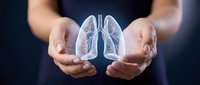 Hands holding a glowing holographic human lung anatomy illustration, symbolizing respiratory health, pulmonary care, and medical awareness concept.