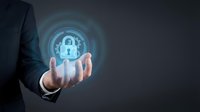 Businessman holding glowing cybersecurity shield with padlock icon for data protection and digital security solutions.