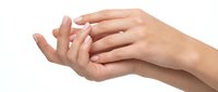 Female hands cupped together in protective gesture on white background, showing care and support concept for healthcare and wellness applications.