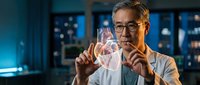 Asian male scientist in lab coat examining transparent molecular model in modern laboratory with blue lighting for research and education.