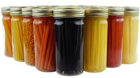 Colorful variety of preserved vegetables and fruits in glass mason jars arranged in row showing home canning and food preservation methods for long term storage.