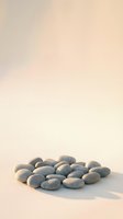 Smooth gray river stones arranged on soft beige surface with warm lighting creating peaceful zen meditation spa wellness atmosphere for relaxation design.