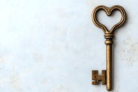 Vintage brass key with heart-shaped bow on white textured background with copy space. Romantic symbol of love and mystery for Valentine's day designs.