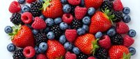 Fresh mixed berries collection with strawberries, blueberries, raspberries and blackberries on white background for healthy eating and nutrition concepts.