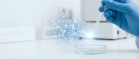 Laboratory scientist in blue gloves using pipette with digital network overlay in modern research facility for biotechnology and medical analysis.