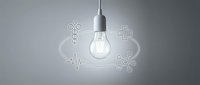 Modern lightbulb with medical icons including caduceus, cross, heartbeat line and molecular structure on gray background for healthcare innovation concepts.