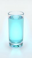Glass of fresh turquoise water isolated on white background, suitable for beverage, health, wellness, and hydration design projects.