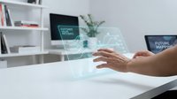 Modern businessman interacting with holographic interface displaying network technology and data visualization on desk in contemporary office environment.