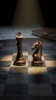 Wooden chess pieces king and knight on chessboard with dramatic lighting and books in background for strategic thinking and intellectual pursuits.