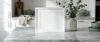 Modern white picture frame mockup on marble kitchen counter with green dinnerware and eucalyptus plant for home decor and product display.