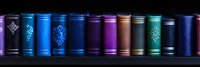 Row of vintage hardcover books with ornate spines in vibrant blue, purple, and green hues against black background, creating dramatic library shelf panorama.