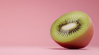Fresh ripe kiwi fruit half showing juicy green flesh and black seeds on pink background with soft shadow, minimalist food composition.