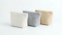 Three minimalist fabric storage baskets in neutral colors white gray and beige arranged on clean background for home organization and interior design.