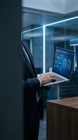 Professional lawyer using laptop with legal software in modern office environment for digital law practice and consultation services.