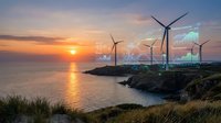 Coastal wind turbines generating renewable energy at sunset with golden light reflecting on ocean water and dramatic sky colors over rocky shoreline landscape.
