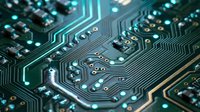 Close-up of circuit board with glowing turquoise pathways and metallic components, showcasing electronic technology and computer hardware design for tech backgrounds.