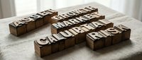 Vintage wooden letterpress blocks spelling asset, growth, market, capital, and risk on a linen surface, evoking finance and investment concepts.