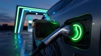Electric vehicle charging at modern station with glowing green lights during twilight hours showcasing sustainable transportation technology.