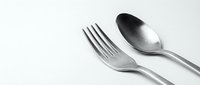 Modern stainless steel fork and spoon cutlery set on clean white background, isolated kitchen utensils for dining and food service applications.