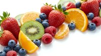 Fresh mixed berries and citrus fruits arranged on white background with strawberries, blueberries, raspberries, kiwi and orange slices for healthy eating.