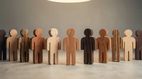 Wooden figurines in various skin tones standing in a row against a neutral wall with overhead lighting, representing diversity, inclusion, and unity in community, workforce, and social concepts.