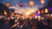 Hand holding lit sparkler with glowing bokeh lights in evening urban setting, suitable for celebration, festive events, New Year, holidays, and joy-themed projects.
